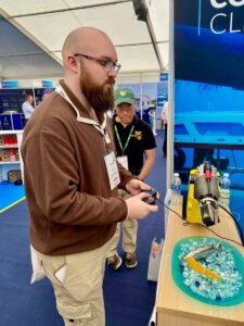 Aquaculture graduate student Jay Haywood puts his robot handling skills to the test at the UCO stand