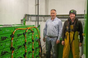 Stewart Rendall, Cooke Scotland’s North Isles Manager, Orkney (L) with site assistant Dean Shearer (R) on Cooke’s Vestness hybrid barge