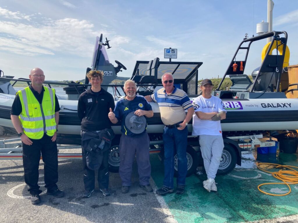 Harry Besley with support team at a stopover, Port Ellen, Islay