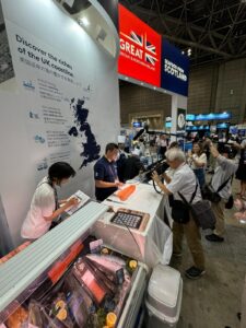 Adam Wing (centre) demonstrates Scottish salmon