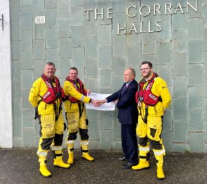 the conference raffle raised funds for the Royal National Lifeboat Institution (RNLI). Pictured (L-R) Mark Scott, Aly Cerexhe and Cameron Scott of the RNLI with Nick Lake